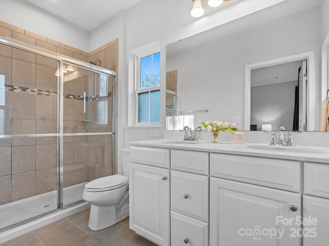 bathroom featuring vanity, toilet, tile patterned floors, and walk in shower