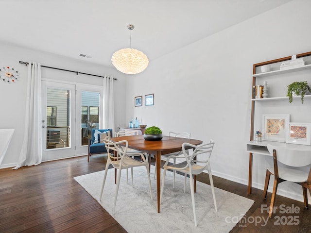 dining area featuring dark wood-type flooring