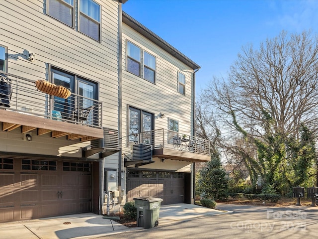 exterior space with a garage and a balcony