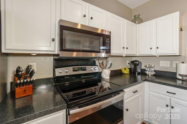 kitchen with white cabinetry and appliances with stainless steel finishes