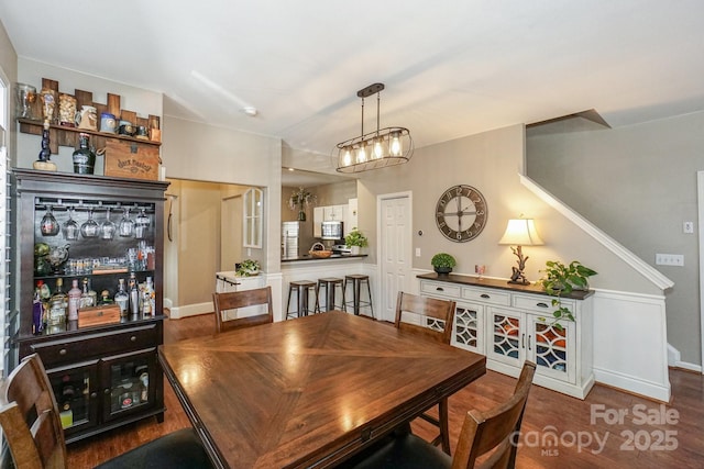 dining space with hardwood / wood-style flooring