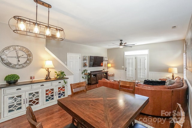 dining space with hardwood / wood-style flooring and ceiling fan