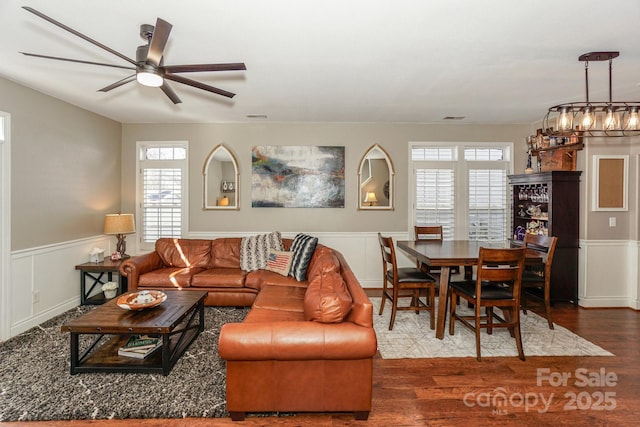 living room featuring ceiling fan, a healthy amount of sunlight, and wood-type flooring