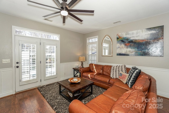 living room with ceiling fan and wood-type flooring