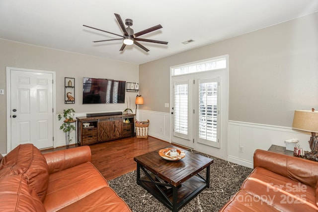 living room featuring ceiling fan and dark hardwood / wood-style flooring