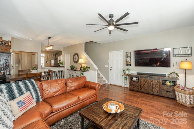 living room featuring ceiling fan and hardwood / wood-style floors