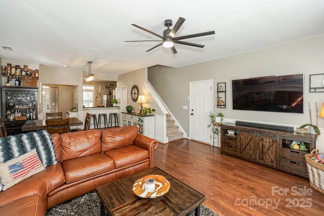 living room featuring ceiling fan and hardwood / wood-style floors