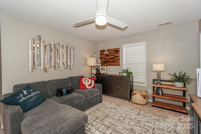 living room featuring ceiling fan and light colored carpet