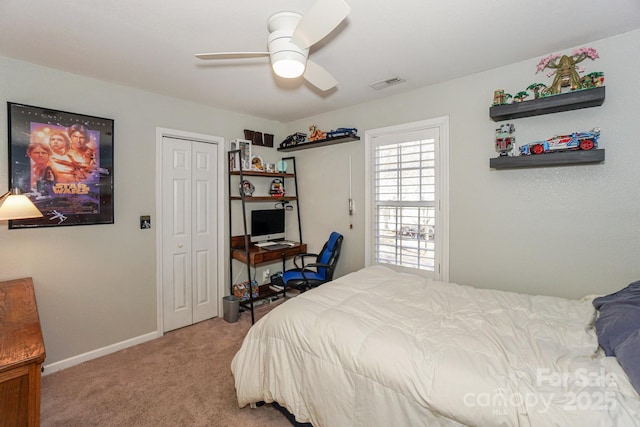 carpeted bedroom with ceiling fan and a closet