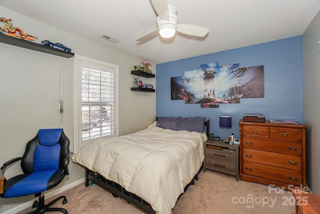 bedroom with ceiling fan and light carpet