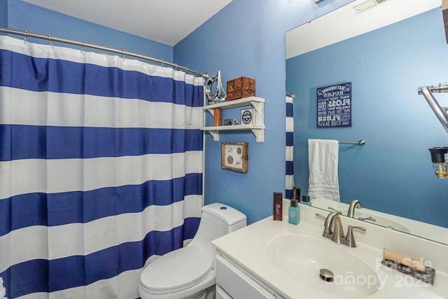 bathroom with toilet, vanity, and a shower with shower curtain