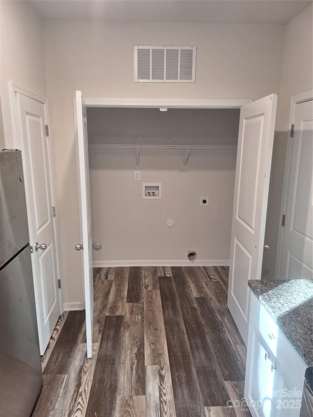 washroom featuring washer hookup, dark wood-type flooring, hookup for a gas dryer, and electric dryer hookup