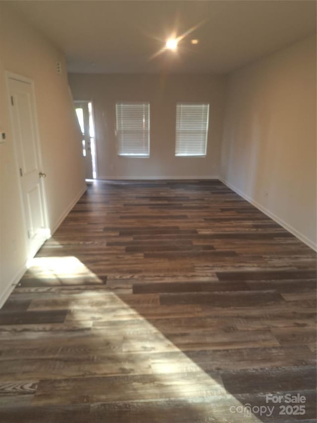 empty room with dark wood-type flooring