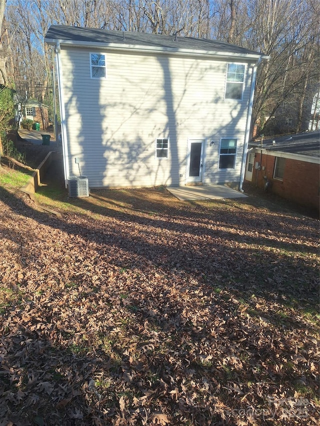 rear view of house featuring cooling unit and a patio