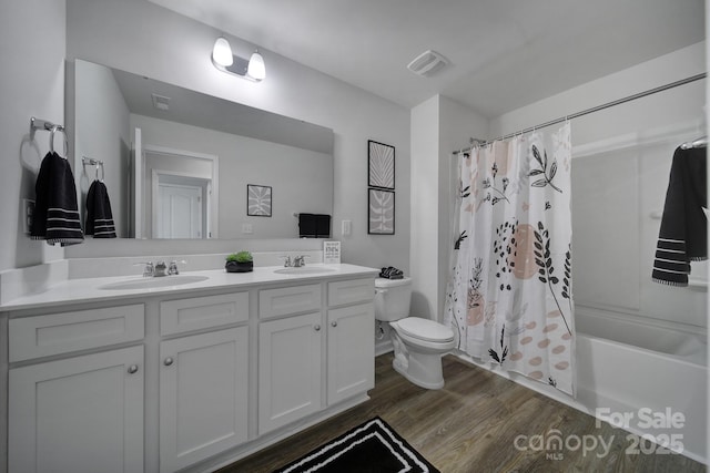 full bathroom featuring toilet, shower / tub combo, vanity, and wood-type flooring