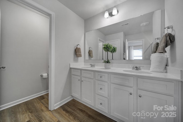 bathroom with vanity and hardwood / wood-style floors