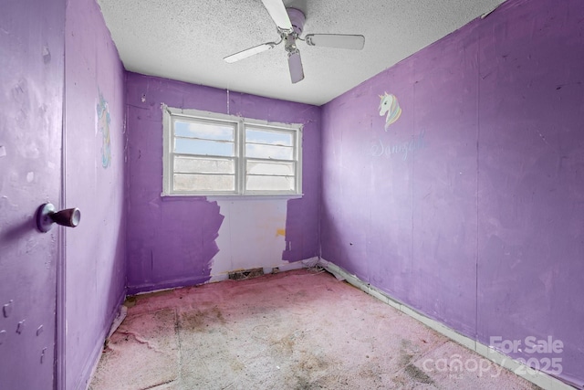 empty room with carpet flooring, a textured ceiling, and ceiling fan