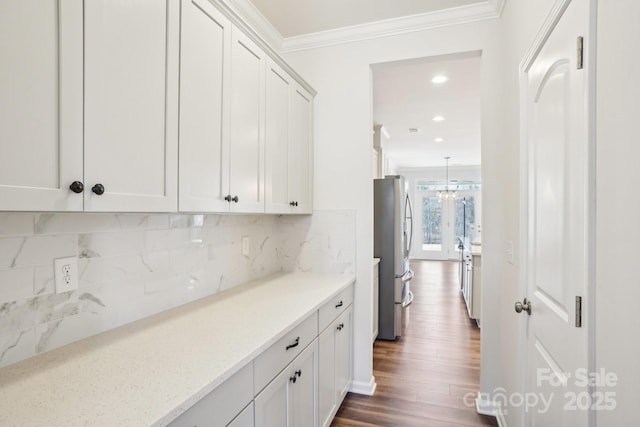 bar with dark wood finished floors, freestanding refrigerator, crown molding, backsplash, and recessed lighting