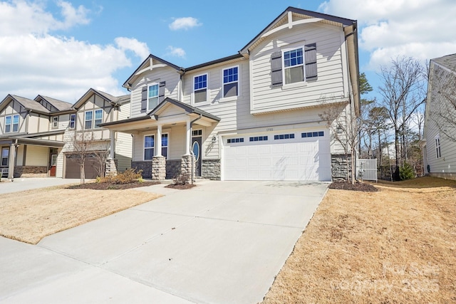 craftsman-style home featuring a garage, stone siding, covered porch, and concrete driveway