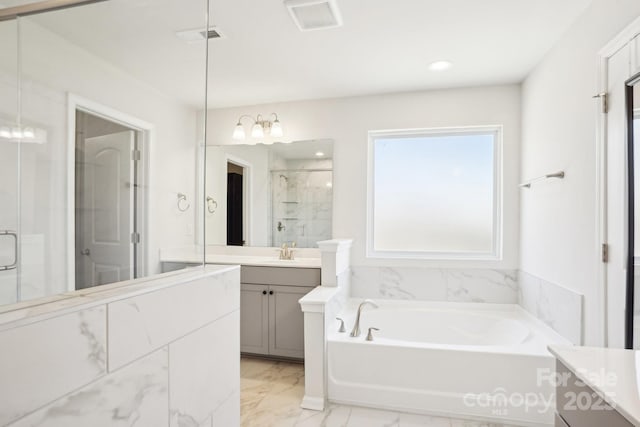 bathroom featuring marble finish floor, a garden tub, visible vents, a shower stall, and vanity