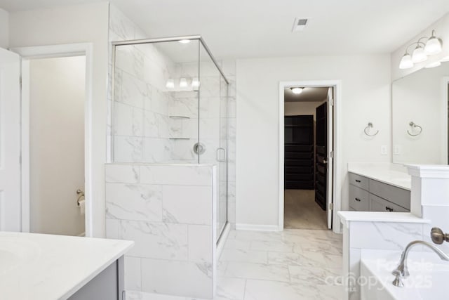 bathroom with visible vents, marble finish floor, a garden tub, vanity, and a shower stall