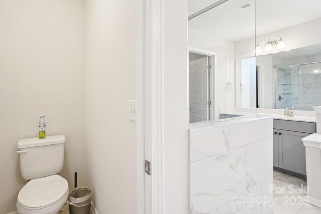 full bathroom featuring visible vents, walk in shower, vanity, and toilet