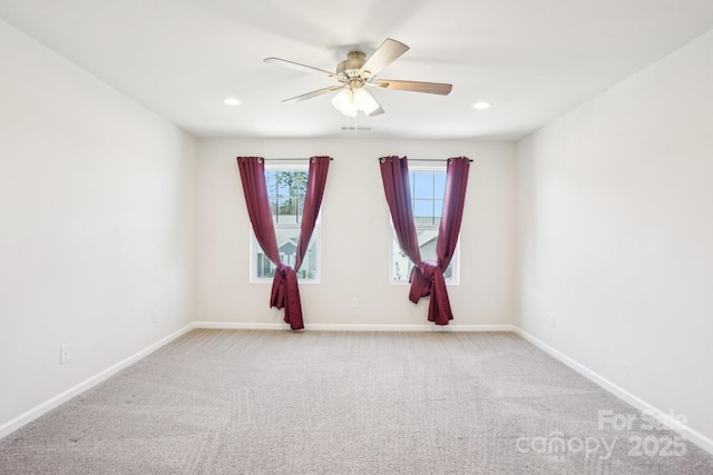 spare room featuring light carpet, recessed lighting, a ceiling fan, and baseboards