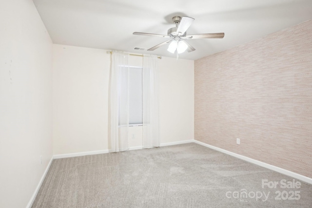 unfurnished room featuring visible vents, baseboards, a ceiling fan, and light colored carpet