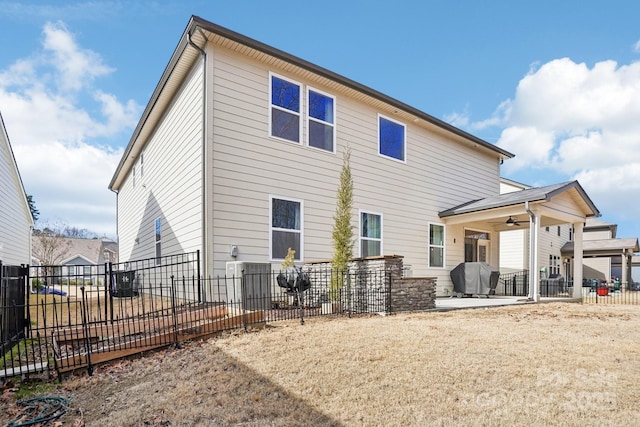 back of house with a patio area, ceiling fan, and fence