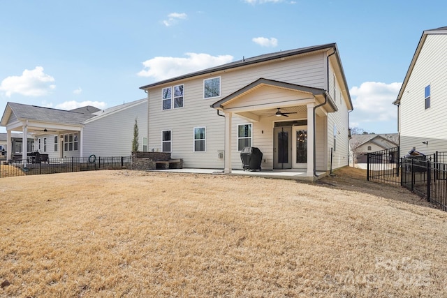 back of house with a ceiling fan, a patio area, a yard, and fence