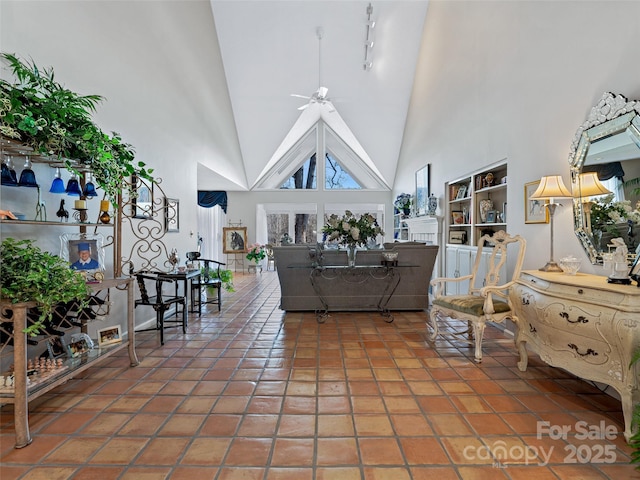 tiled living room with a towering ceiling and ceiling fan