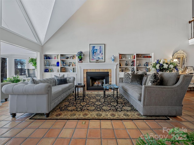 tiled living room featuring high vaulted ceiling and a tile fireplace