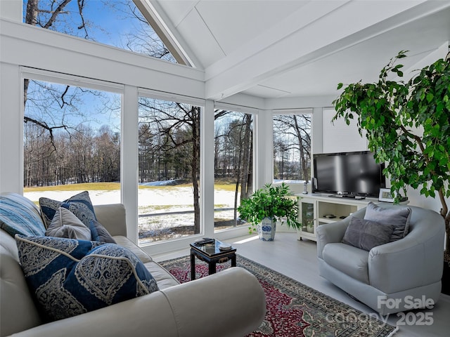 sunroom with vaulted ceiling and plenty of natural light