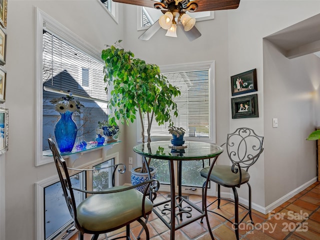 dining room with ceiling fan, a healthy amount of sunlight, and light tile patterned floors