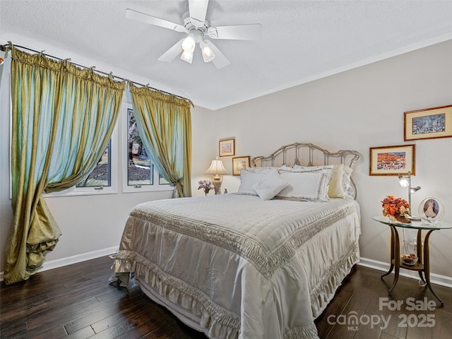 bedroom with crown molding, a textured ceiling, dark hardwood / wood-style floors, and ceiling fan