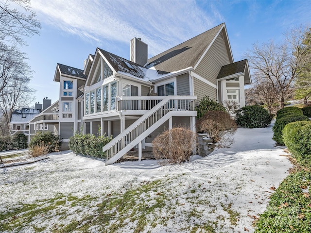 view of snow covered back of property