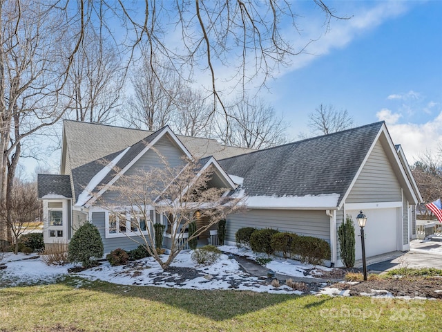 view of front of home with a front yard and a garage