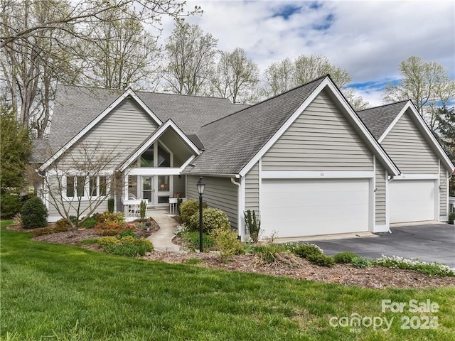 view of front of house featuring a garage and a front lawn