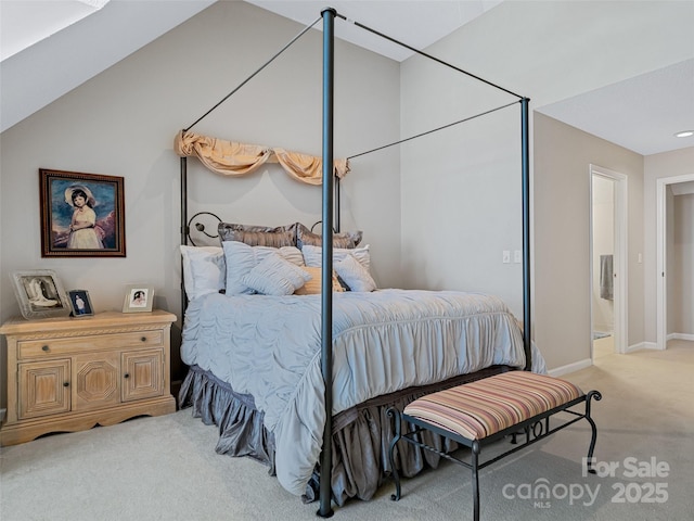 bedroom featuring vaulted ceiling, baseboards, and light colored carpet