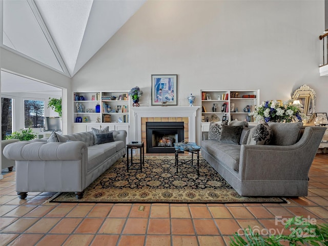 living room with tile patterned flooring, a tile fireplace, and high vaulted ceiling