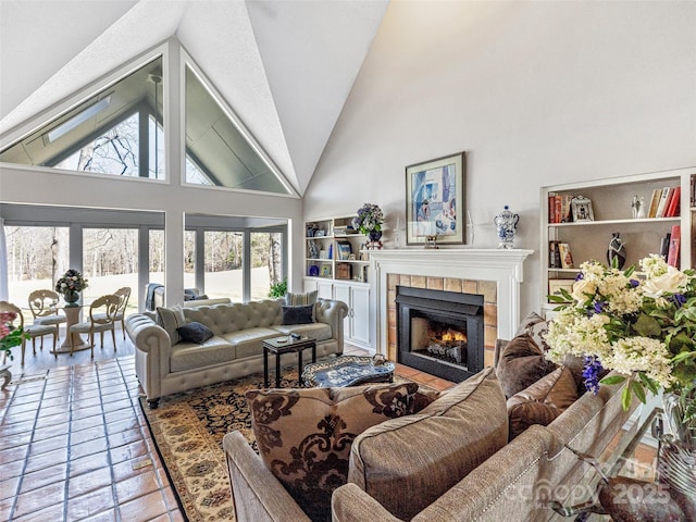 living area with high vaulted ceiling and a fireplace