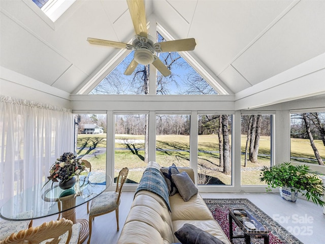 sunroom featuring plenty of natural light and high vaulted ceiling