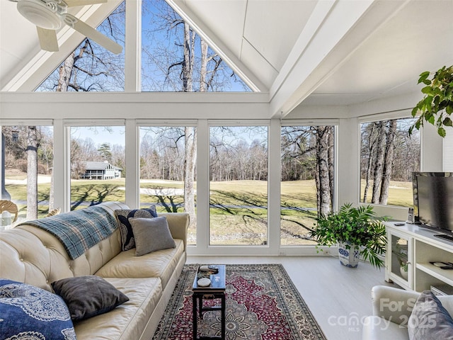 sunroom with a ceiling fan, high vaulted ceiling, and an outdoor living space