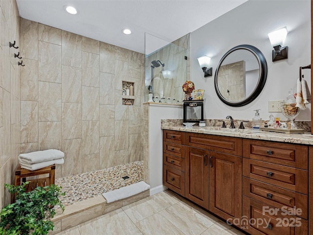 bathroom featuring vanity, recessed lighting, and a walk in shower