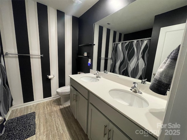 bathroom with vanity, toilet, and hardwood / wood-style floors