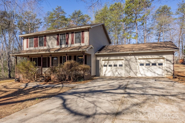 view of front of property with covered porch, an attached garage, and concrete driveway