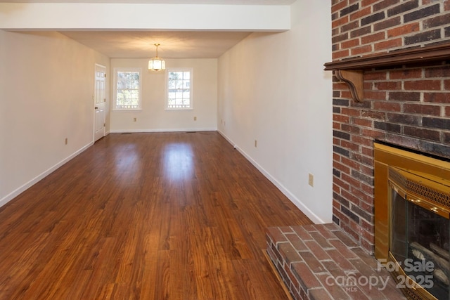 unfurnished dining area with baseboards, dark wood-style floors, and a fireplace