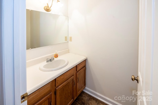 bathroom with baseboards, vanity, and tile patterned flooring