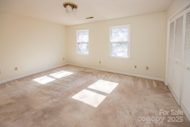 unfurnished bedroom with visible vents, baseboards, and carpet