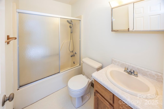 bathroom with vanity, toilet, and combined bath / shower with glass door